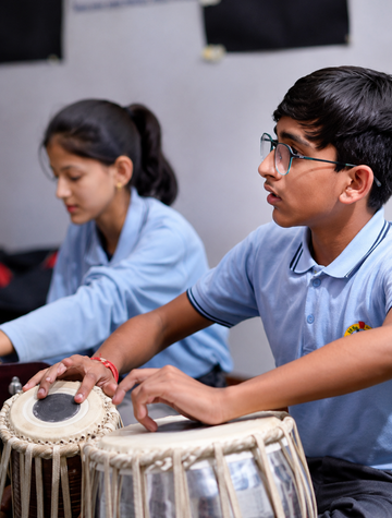 Students playing tabla
